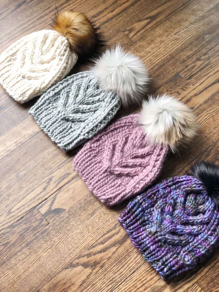 Staghorn cable knit hats with faux fur pom poms